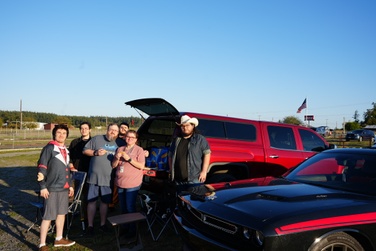 family enjoying food at their vehicle at the blue fox drive-in