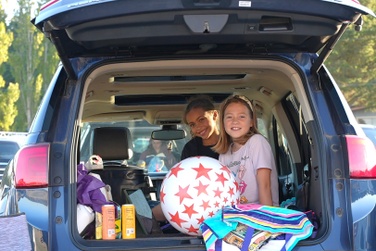 two girls in the back of a vehicle at the blue fox drive-in