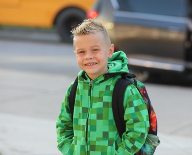 A student smiles on the first day of school