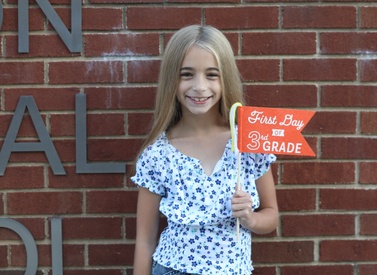 A student poses prior to the first day of school