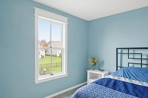 Bedroom interior with blue walls and white window