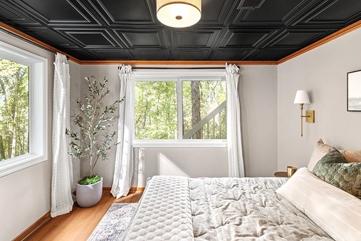 Bedroom interior with a white slider window.