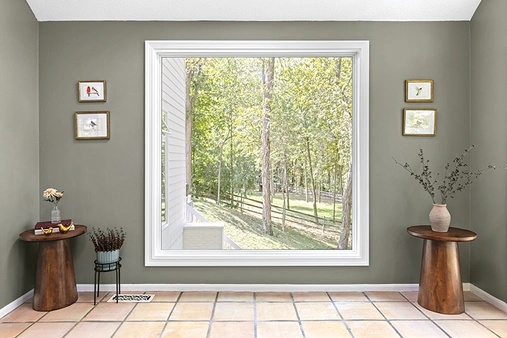 Sunroom interior with a large white picture window.