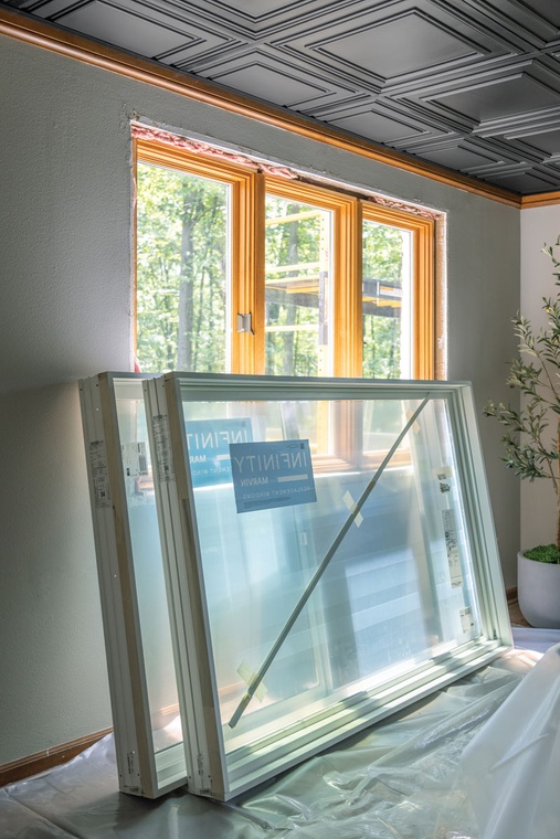 Home interior with two large white Infinity from Marvin windows stacked together against a wall.