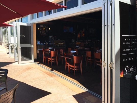 Exterior of a restaurant featuring Marvin Coastline hurricane rated replacement bi-fold doors