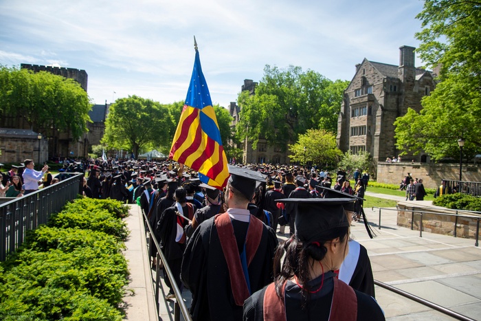 Documentation of the 2022 Yale School of Art commencement, with the banner carried each year by a graduating student.