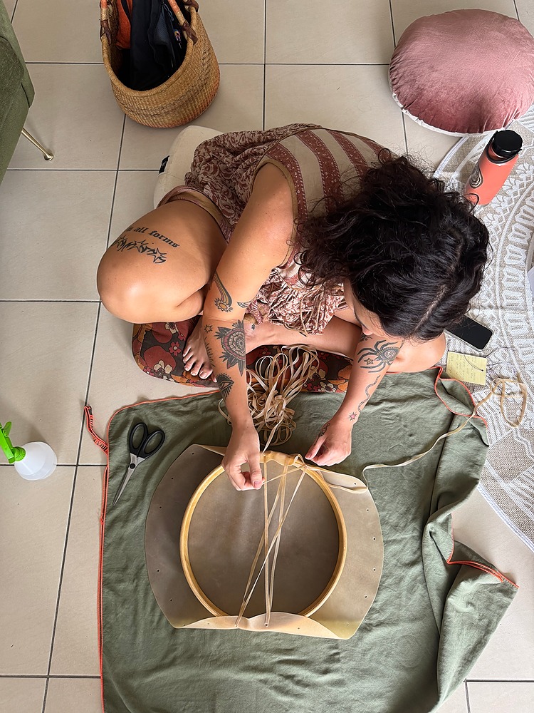 A woman starting to lace her drum