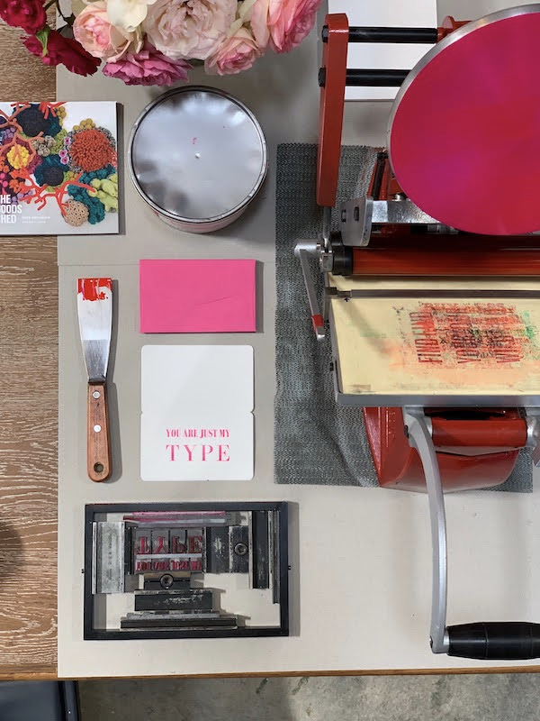 Flat lay of Adana tabletop press forme ink and paper