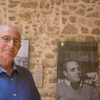 Sidney Corcos next to a picture of his father in the exhibition space of Bayt Dakira, 2. Photograph courtesy of World Monuments Fund, Stories of the Mellah Cultural Mapping project. Photo: L. Brandt