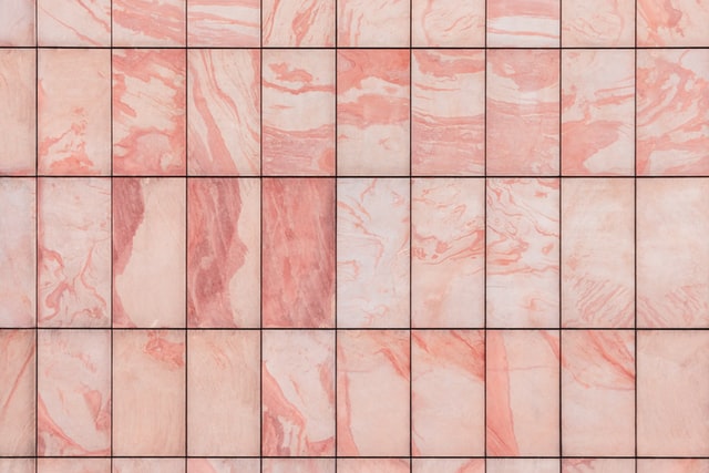 Pink marble bathroom tile over concrete.