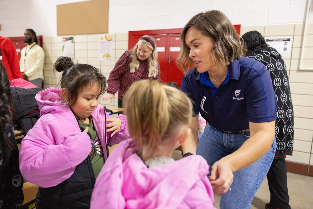 A Ferrellgas employee-owner distributes coats in mid-October to students at Madison Elementary School in Des Moines, Iowa. 