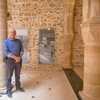 Sidney Corcos next to a picture of his father in the exhibition space of Bayt Dakira. Photograph courtesy of World Monuments Fund, Stories of the Mellah Cultural Mapping project. Photo: L. Brandt
