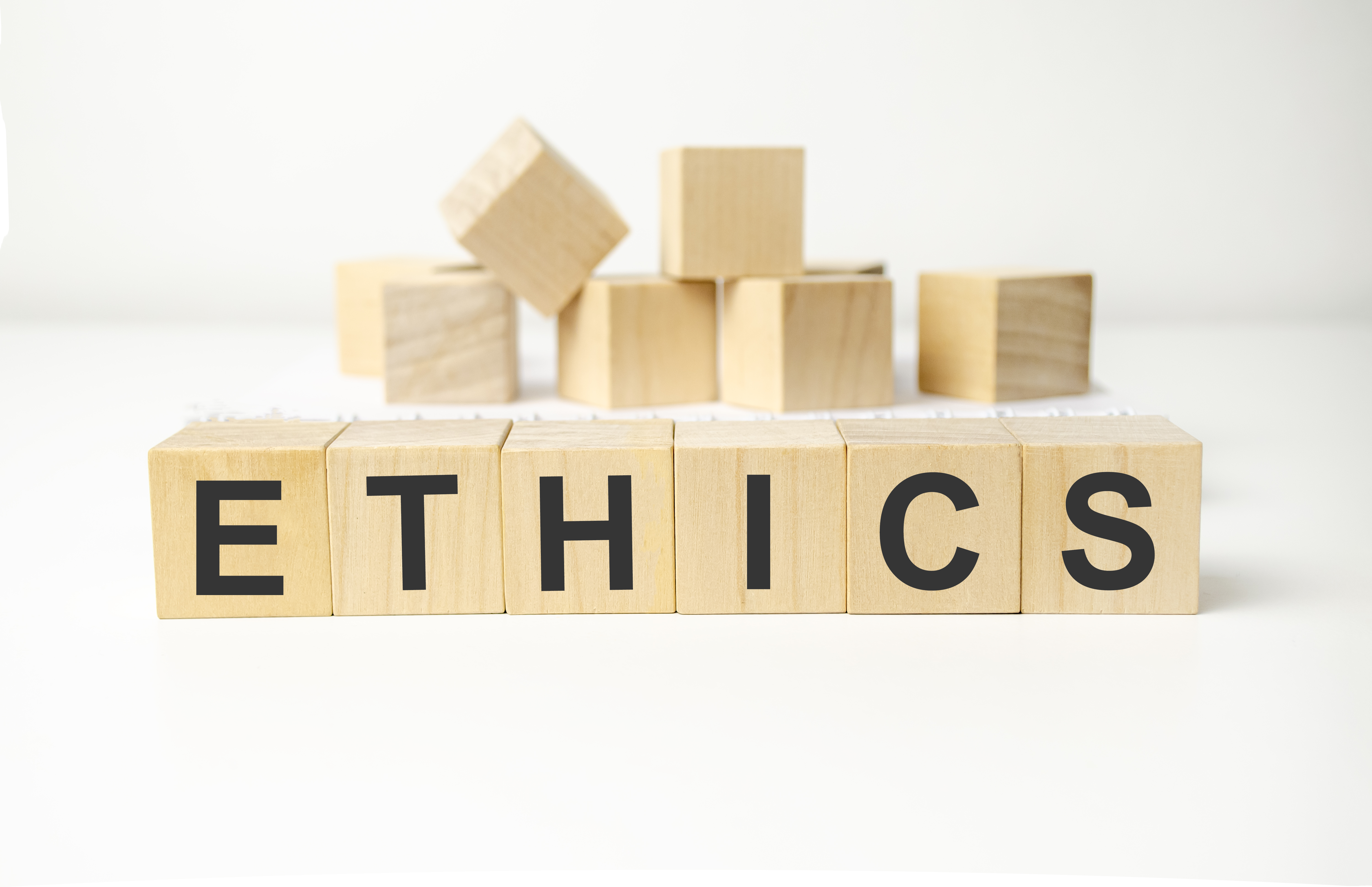 wooden blocks with letters that spell ethics